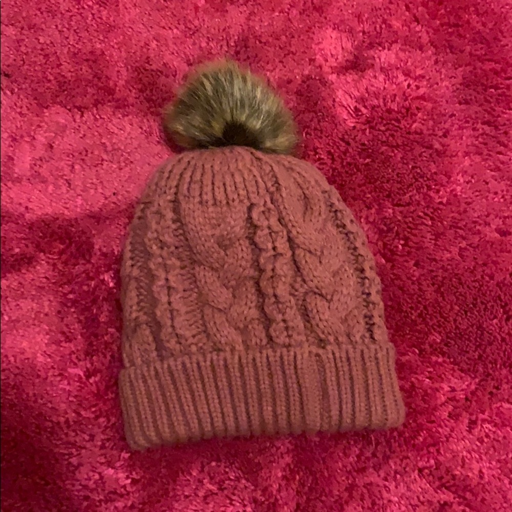 Pale pink Pom Pom Hat with a faux fur inside.